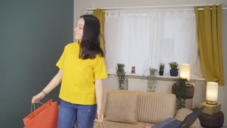 dancing young woman with shopping bags.