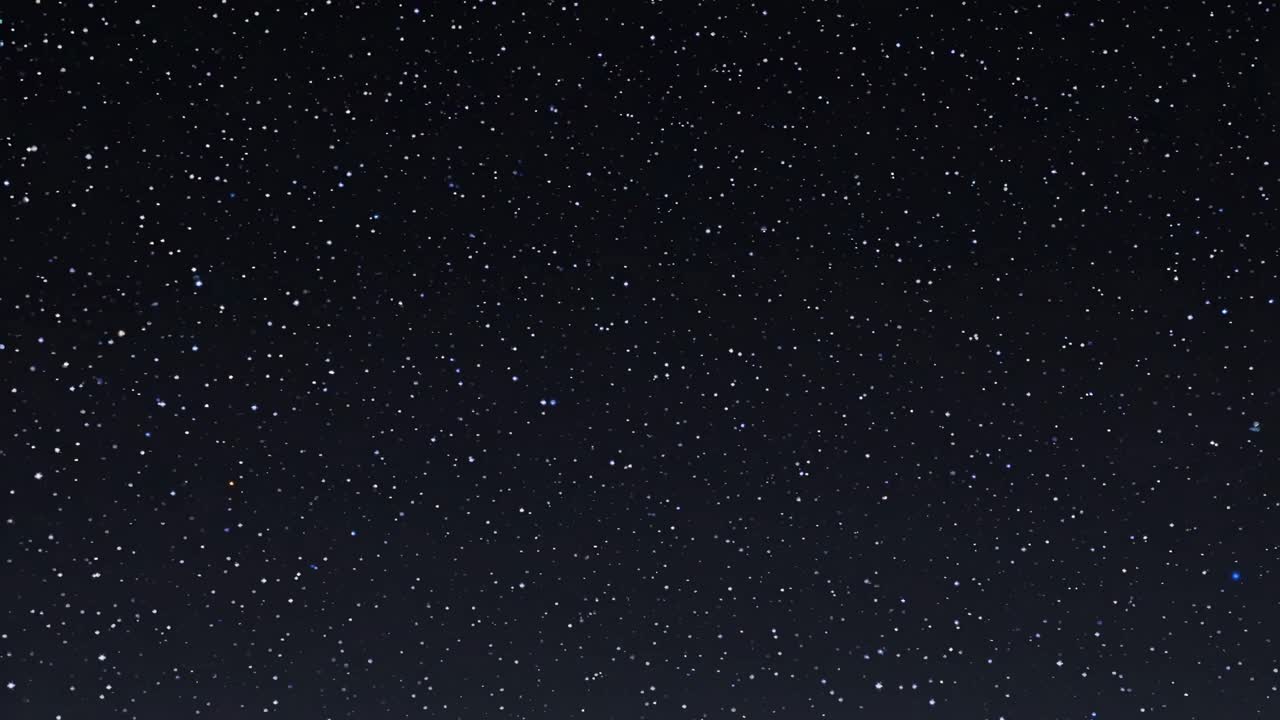 The video captures a serene night sky filled with twinkling stars, evoking a sense of wonder