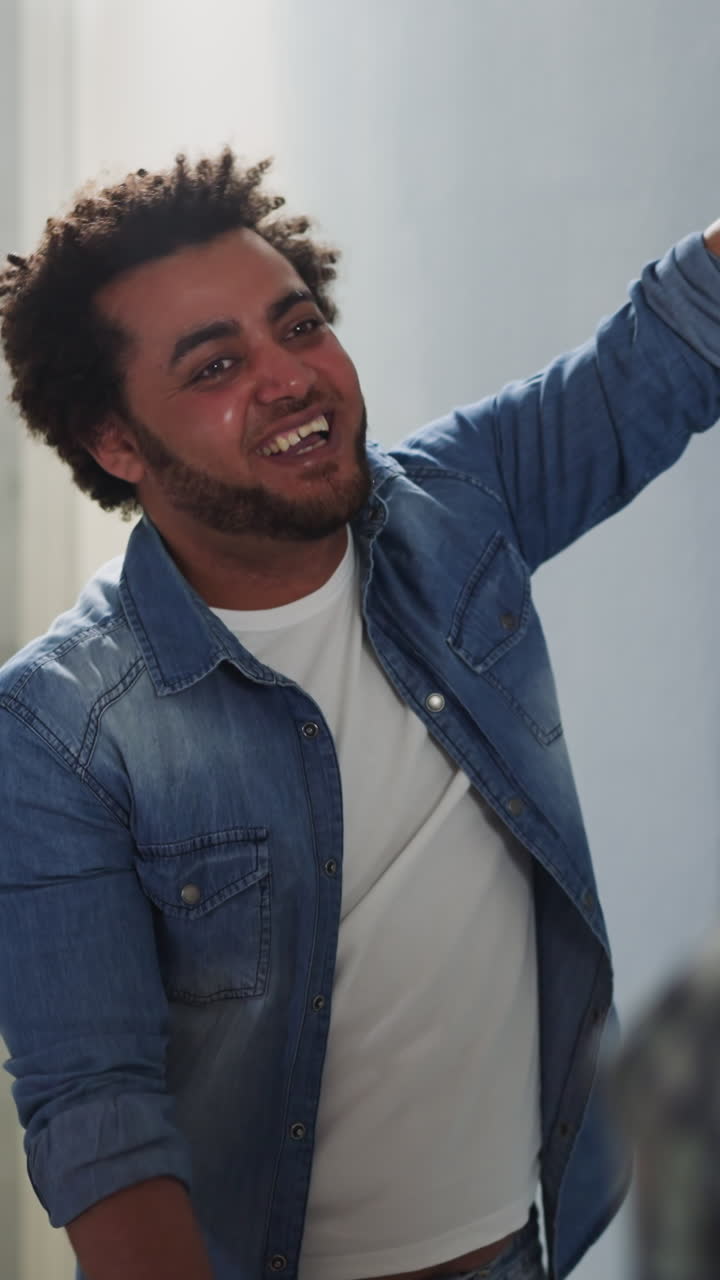 African-American man laughs discussing wallpaper style with friend in flat closeup. Black designers search ideas for house decor. Creative work at restore