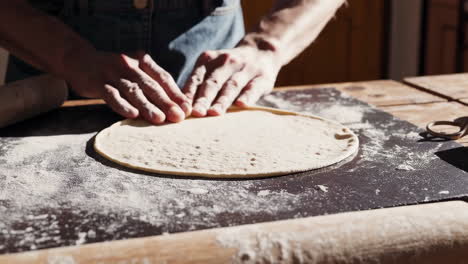 hands kneading dough for pizza or flatbread