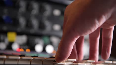 musician playing an analog synthesiser during a session at the recording studio