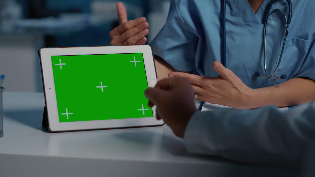 Medical Professionals Discussing Green Screen Tablet