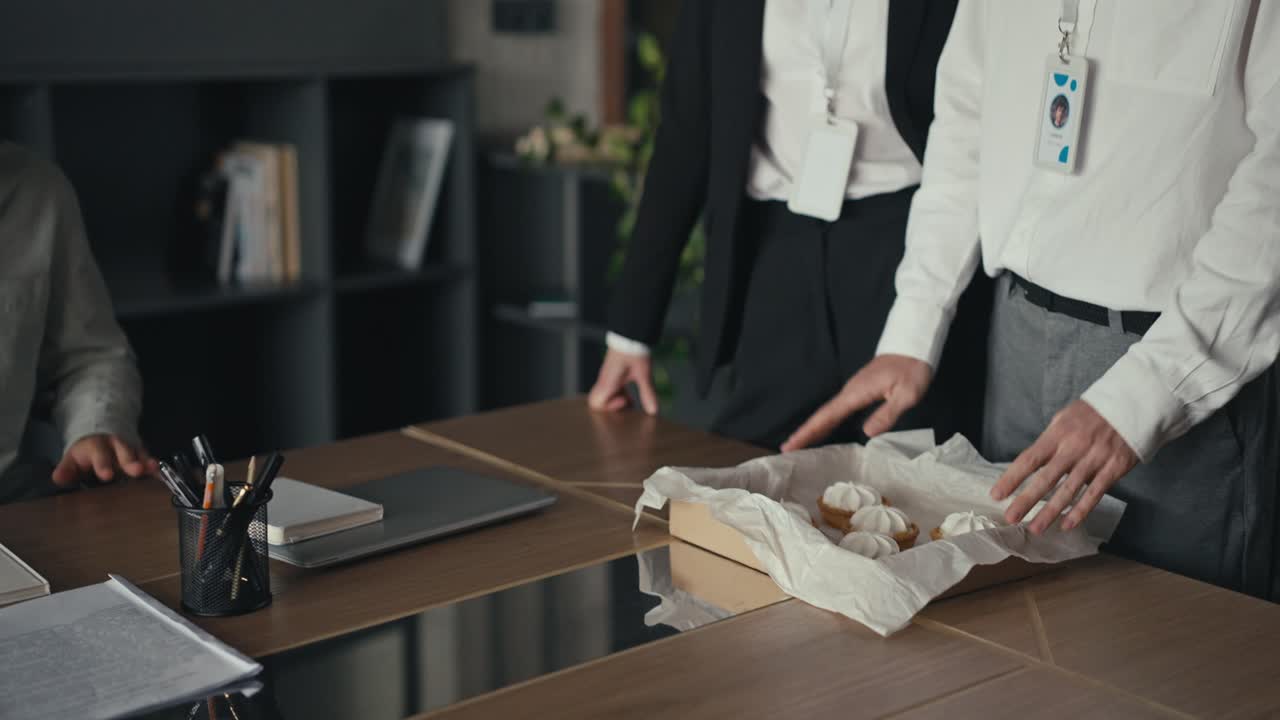 Office workers carrying dessert