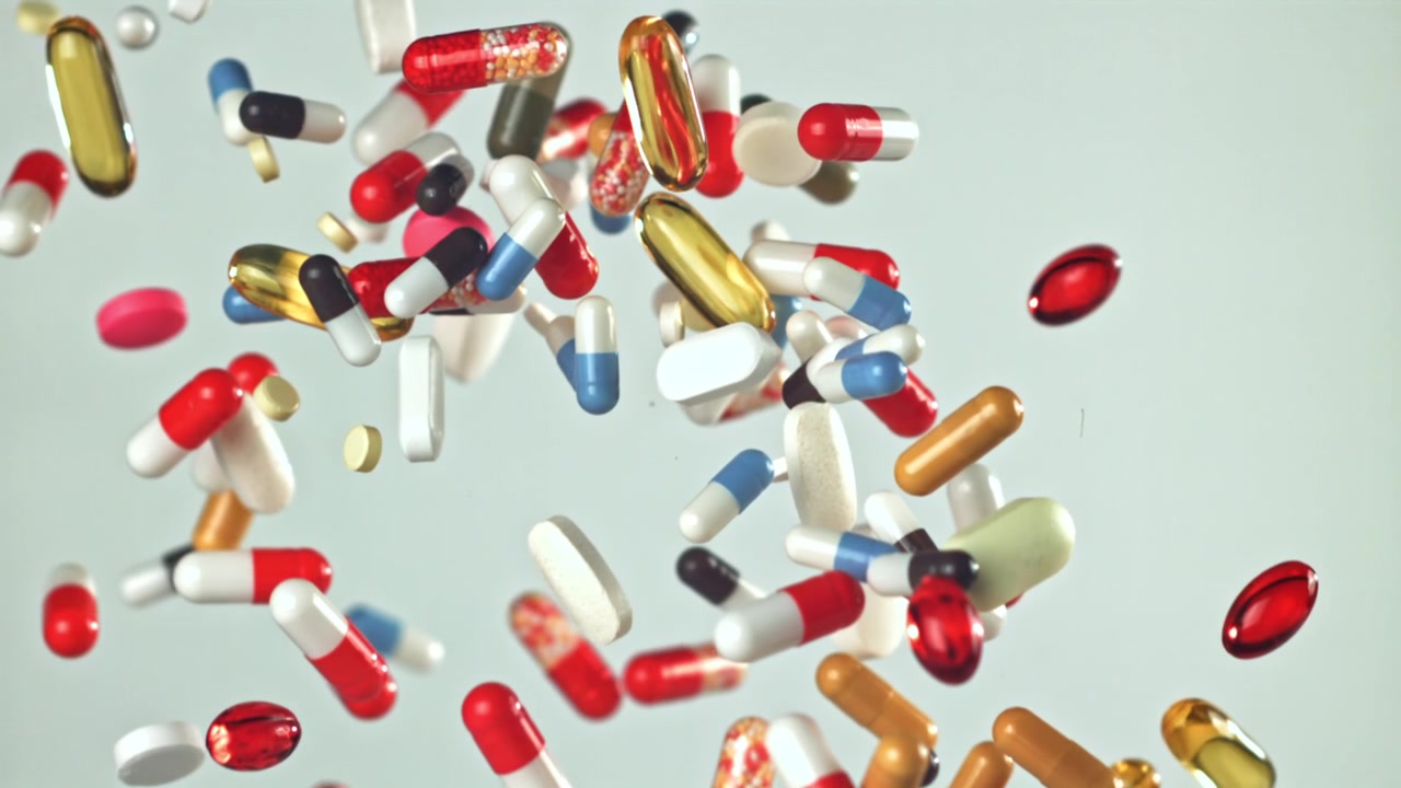 Assortment of Colorful Pills and Capsules Falling in Slow Motion