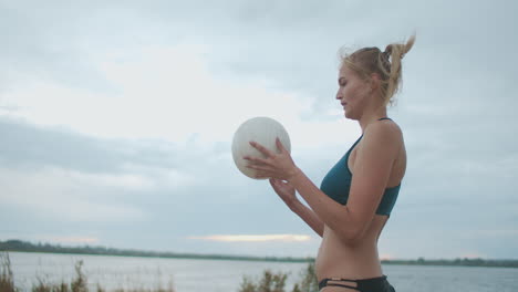 beach volleyball player woman is wearing sporty bikini and playing match women team in championship