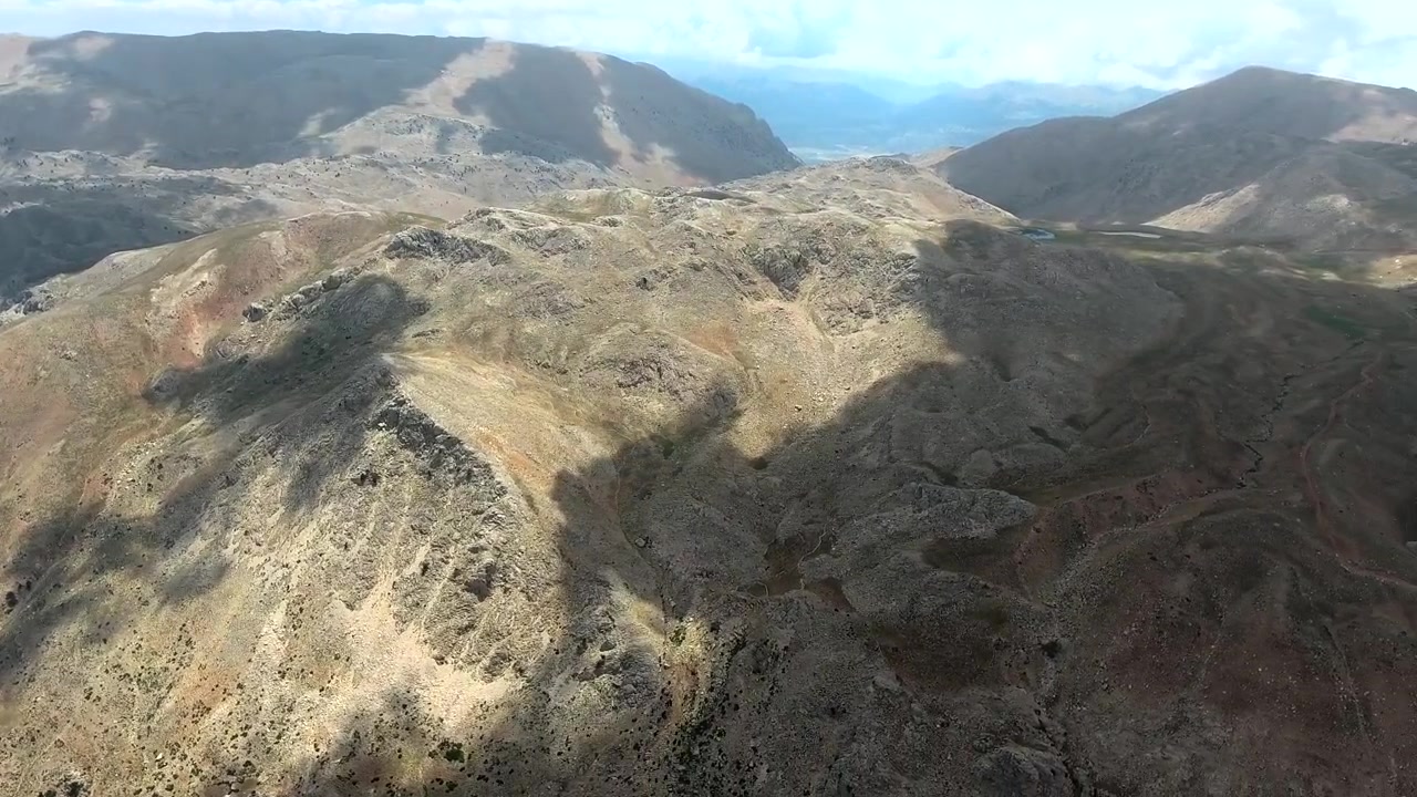 Vista aérea de estrada de montanha sinuosa em paisagem acidentada