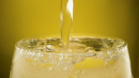 Extreme-close-up-filling-a-drinking-glas-to-the-top-with-sparkling-water