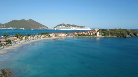 4K-Aerial-View-of-Cruise-Ship-Docked-at-a-Port-in-the-Caribbean-in-St-Maarten-Divi-Little-Bay-Push-Shot