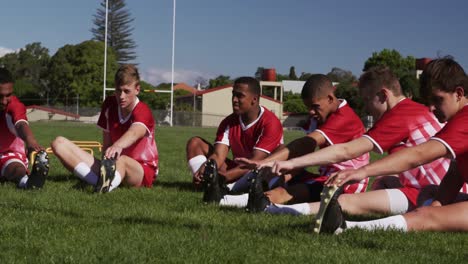 rugby players stretching on the field