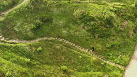 an athletic man running up steps on a countryside path