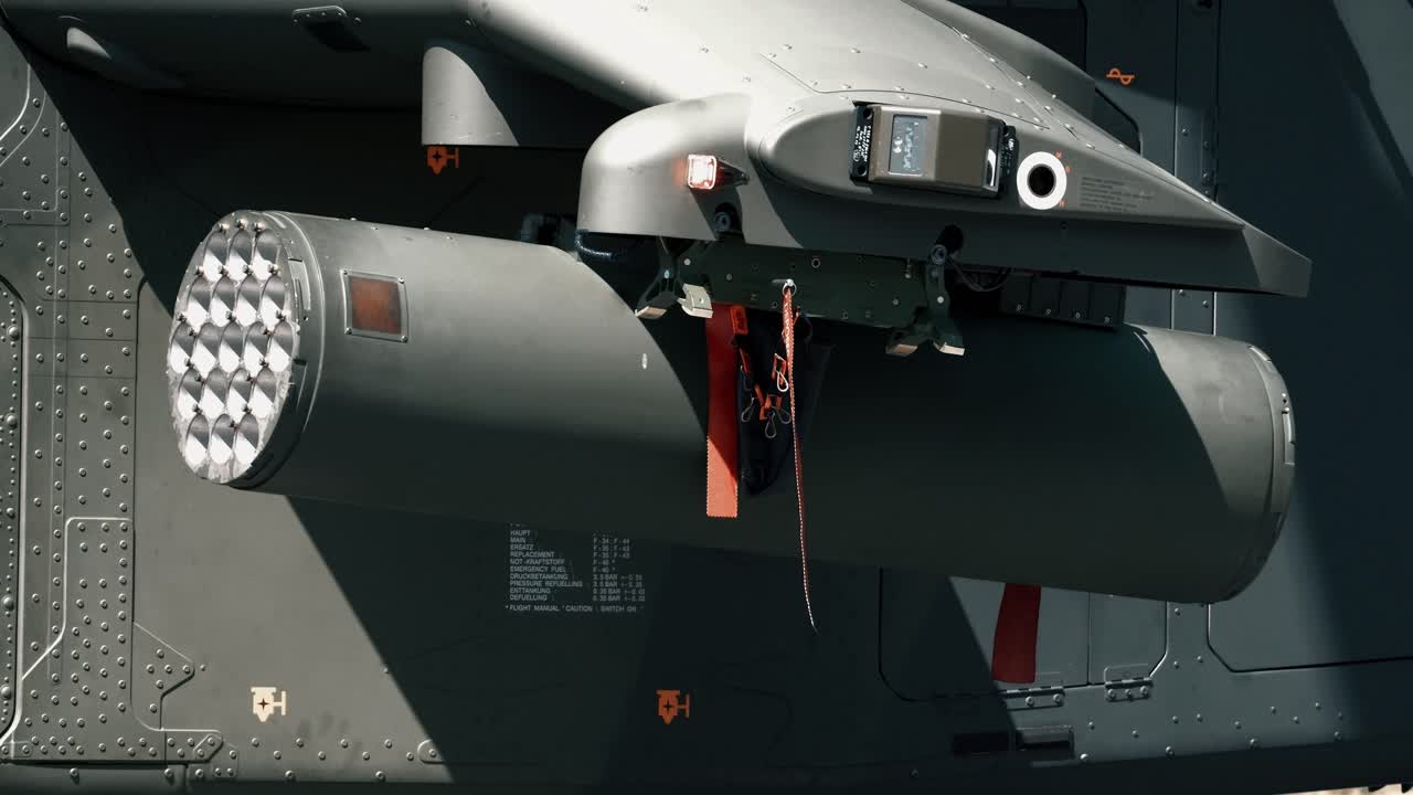 You can see an military attack helicopter and its weapons. Alpha has a Remove before fly band attached to it.