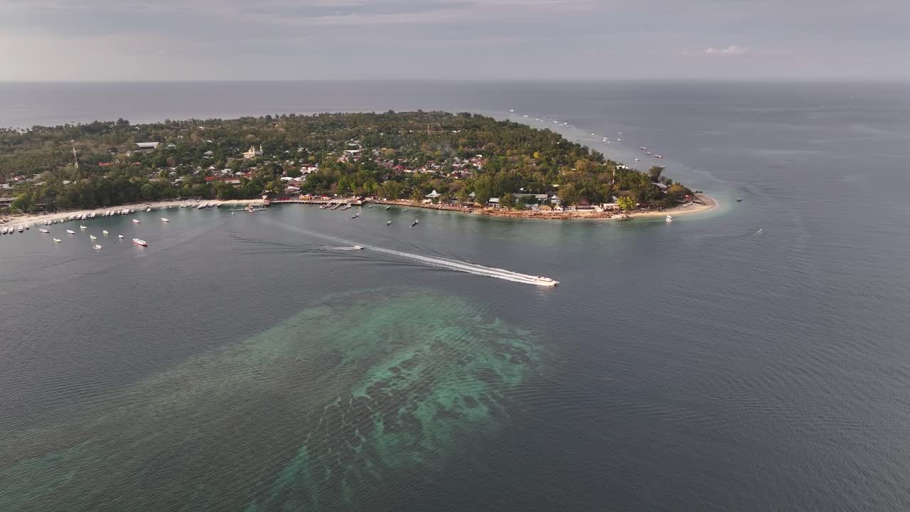 Ferry is leaving peaceful Gili Air island in Indonesia. Travel holiday destination. Aerial panoramic