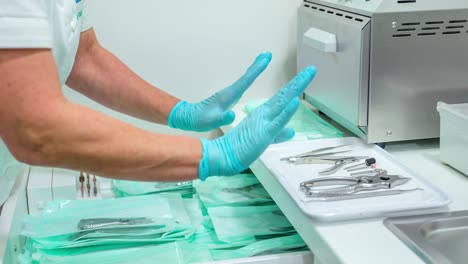 pedicurist sorts sterile stainless steel pedicure tools on tray