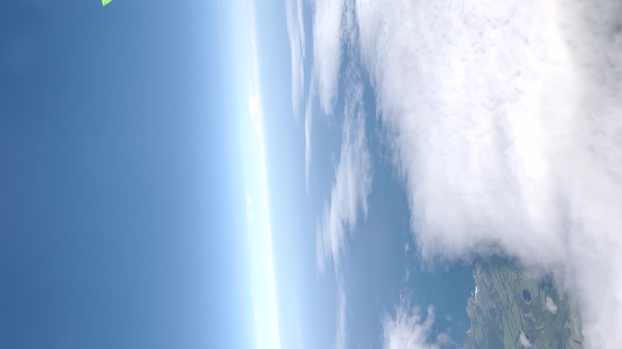 Stunning Aerial View of Clouds and Landscape during Skydiving