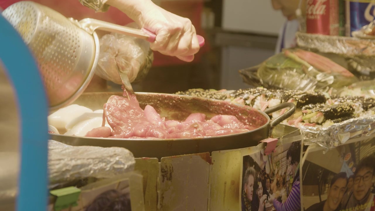 Un vendedor de mercado cocinando tteokbokki en el Mercado de Gwangjang, Seúl