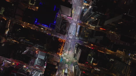 Aerial-birds-eye-overhead-top-down-view-of-glowing-colourful-light-on-Times-Square.-Fly-over-commercial-intersection-at-night.-Manhattan,-New-York-City,-USA