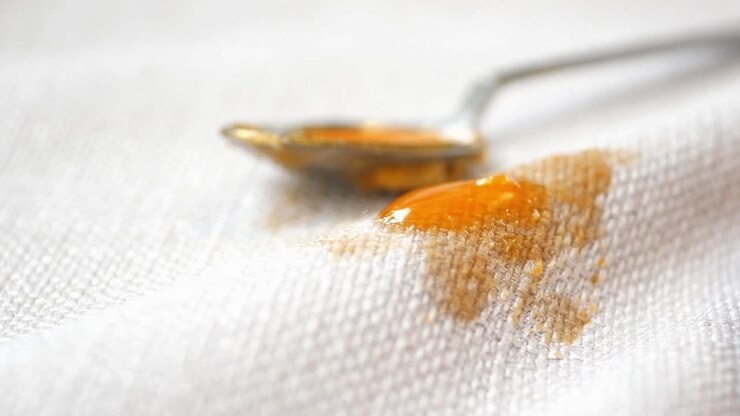 Honey Dripping On A White Cloth