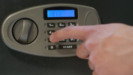 man hand unlock door of safe deposit box and take bundle of dollar bills