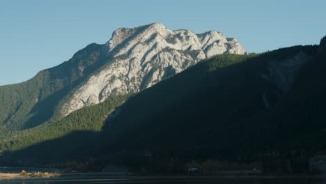 a large canadian rocky mountains towers tall over canada's trans-canada highway near canmore alberta canada