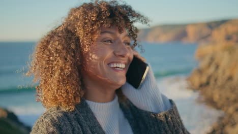 laughing model smartphone call at sea background closeup. excited woman talking