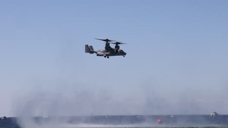 helicopter flying over ocean with increasing mist