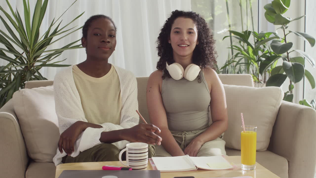 Female Roommates Smiling at Camera when Studying from Home