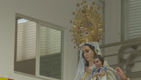 preparation of the image of the virgin of carmen for the procession in the barbate market, cádiz