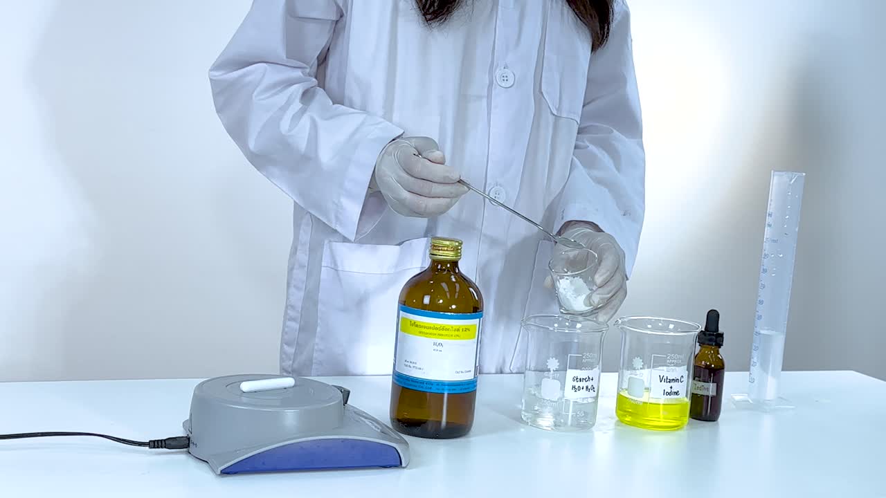 A scientist conducts an iodine clock reaction using vitamin C and starch, demonstrating chemical changes in a lab setting