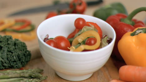 tomatoes dropping in super slow motion into salad