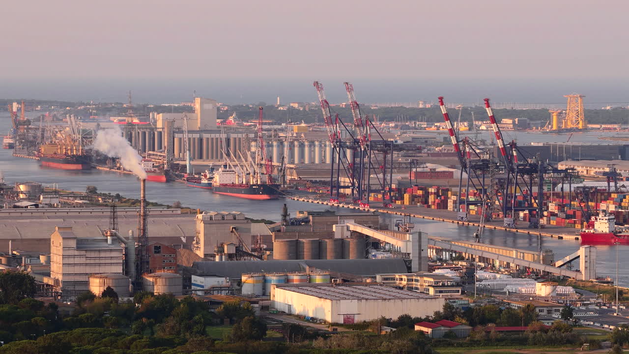Drone view of industrial and port area of Ravenna,production district is made up of a chemical and petrochemical pole, thermoelectric and metallurgical plants at sunset