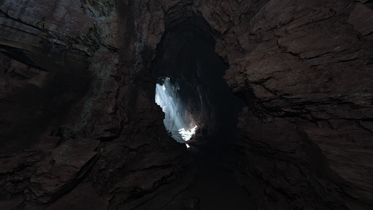 una entrada de cueva oscura con una pequeña luz brillando a través