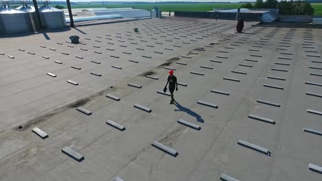 building the solar farm on flat roof. flying over the construction site of future alternative power plant on the top of building. aerial view.