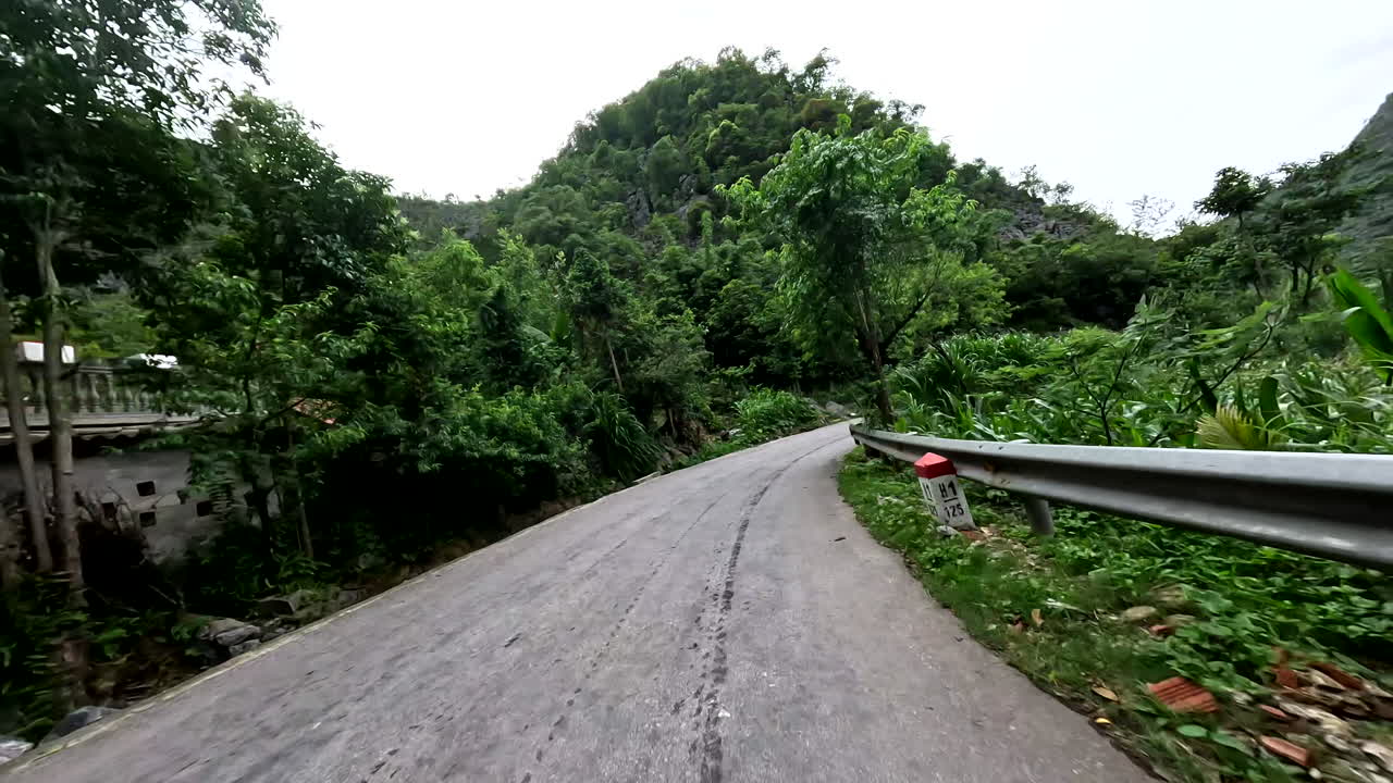 Long Winding Road Of Ha-Giang Loop Passing Through Lush Mountains In Northern Vietnam. POV Shot