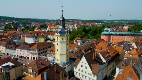 4k aerial drone video of the clock tower on the town wall of downtown ansbach, germany