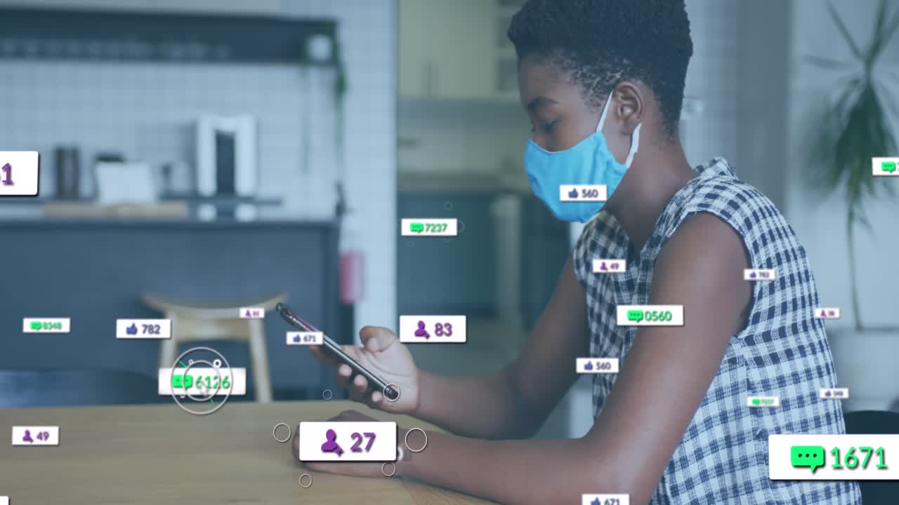 Animation of social media icons over african american woman with face mask using smartphone