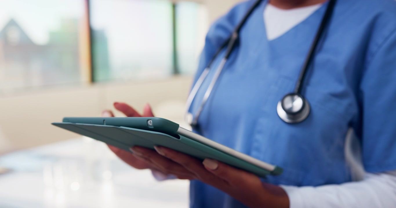 Nurse Using Digital Tablet in Hospital Setting