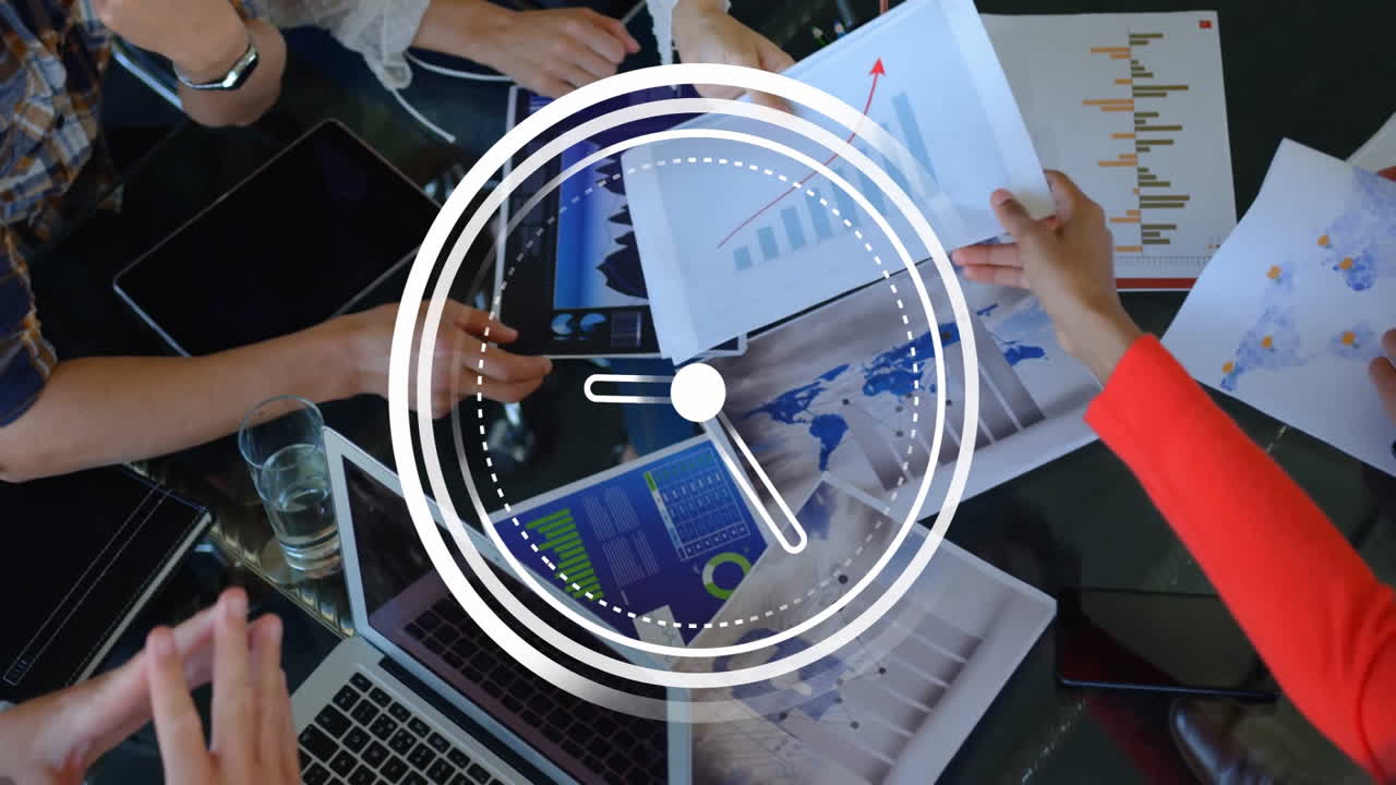 Clock animation over business team analyzing charts and graphs in ...
