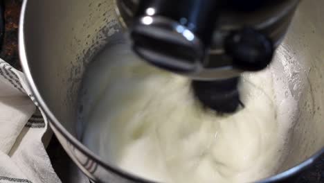 egg whites in mixer being whipped into homemade meringue