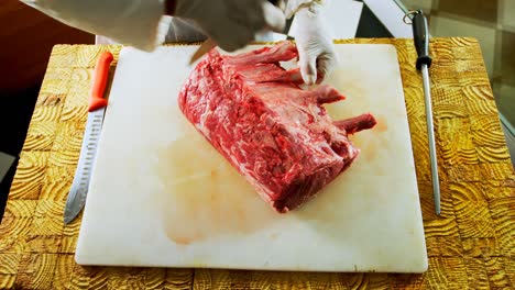 butcher chopping meat on chopping board 4k