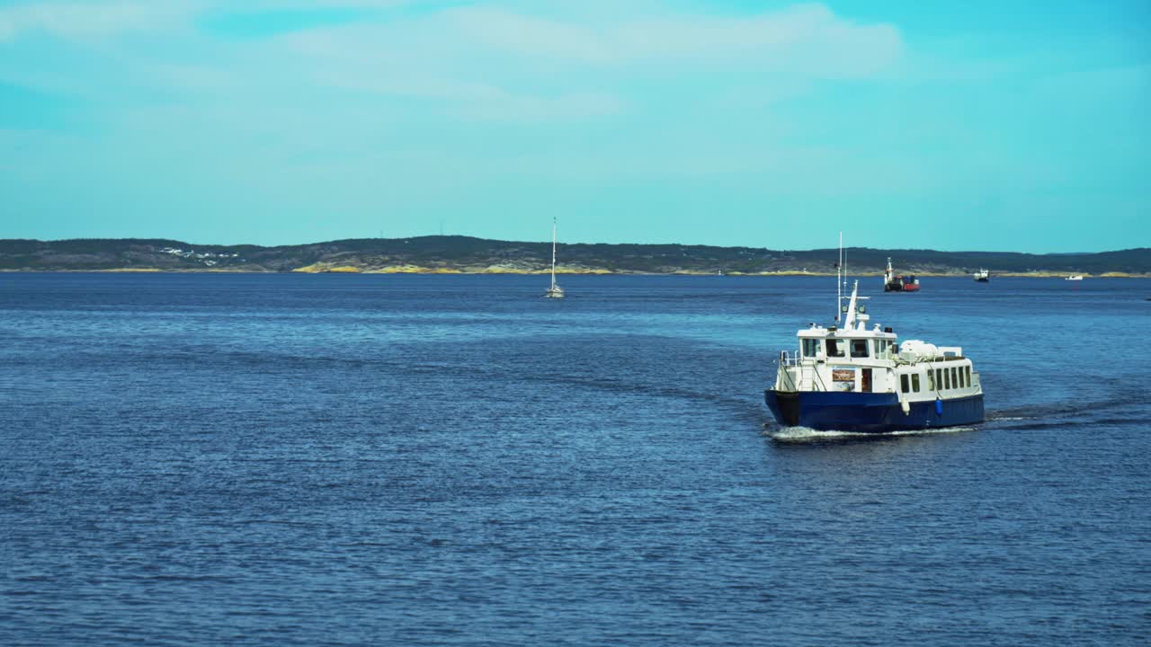 Push in shot of white and blue ferry going to Tjorn island during the day in Bohuslan, Sweden