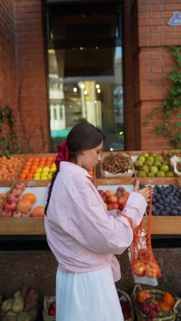 woman shopping for fruits at a street market