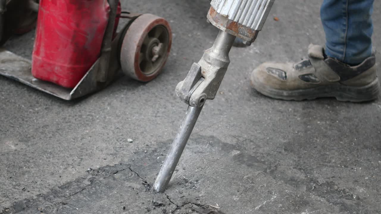 Jackhammer Breaking Pavement