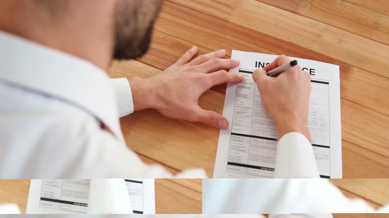 un hombre de negocios sentado en un escritorio llenando un contrato de seguro.