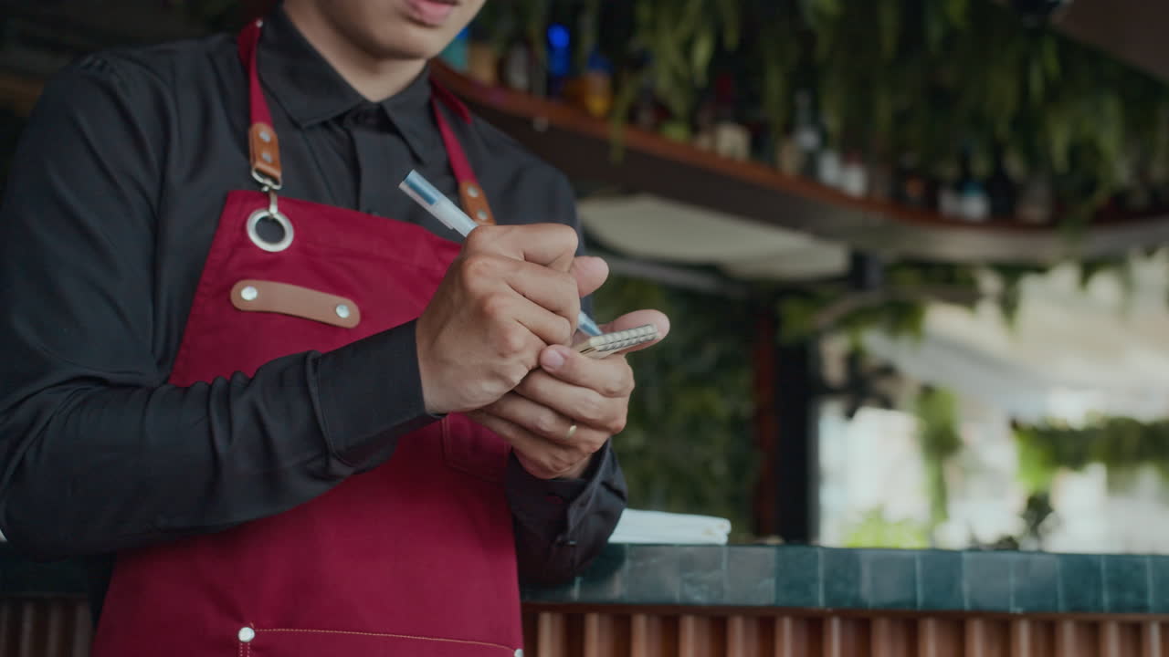 Unrecognizable Waiter Making Notes when Client Ordering Lunch in Cafe