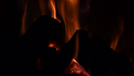 logs burning red hot in a fireplace