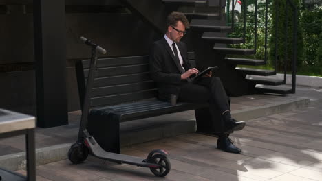 businessman using tablet outdoors