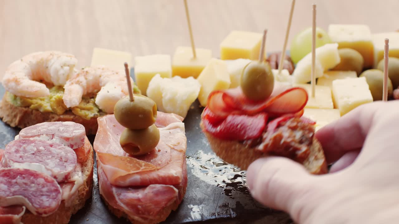 Delicious Tapas Platter with Assorted Meats, Cheeses, and Olives