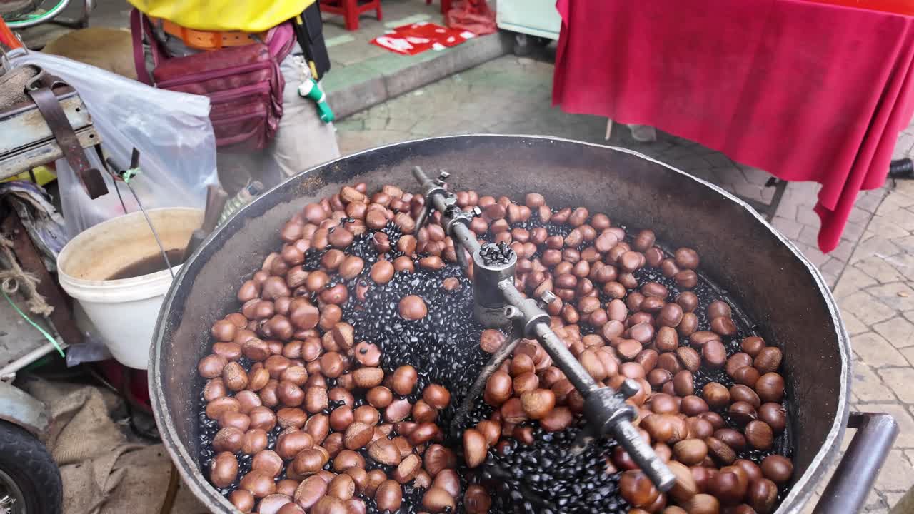 Traditional street food vending machine roasting chestnuts in Chinatown Kuala Lumpur Malaysia