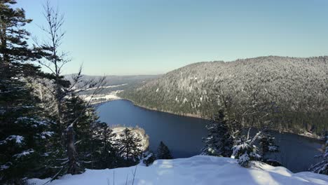 Winter-landscape,-snowy-mountains-and-the-Longemer-lake-in-France