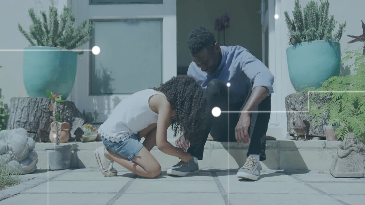 Digital network connections animation over father and daughter tying shoelaces